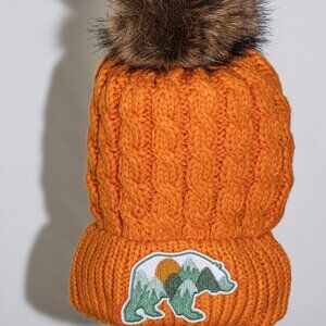 Orange stocking cap with "Mountain Bear" patch and fuzzy lining